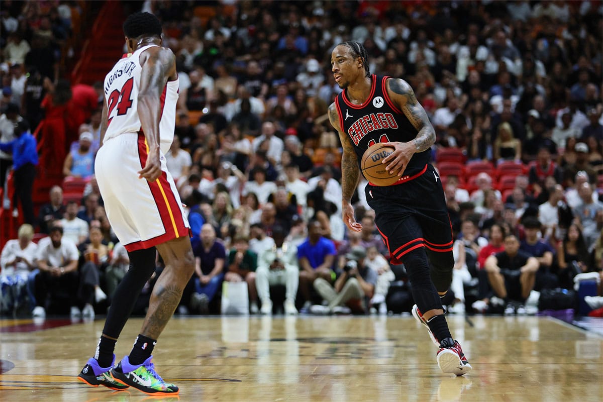  Chicago Bulls forward DeMar DeRozan (11) dribbles the basketball against the Miami Heat in the second quarter during a play-in game of the 2024 NBA playoffs at Kaseya Center.