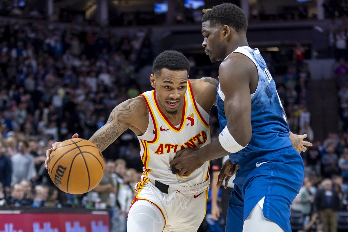 Atlanta Hawks guard Dejounte Murray (5) dribbles the ball around Minnesota Timberwolves guard Anthony Edwards (5) in the first half at Target Center.