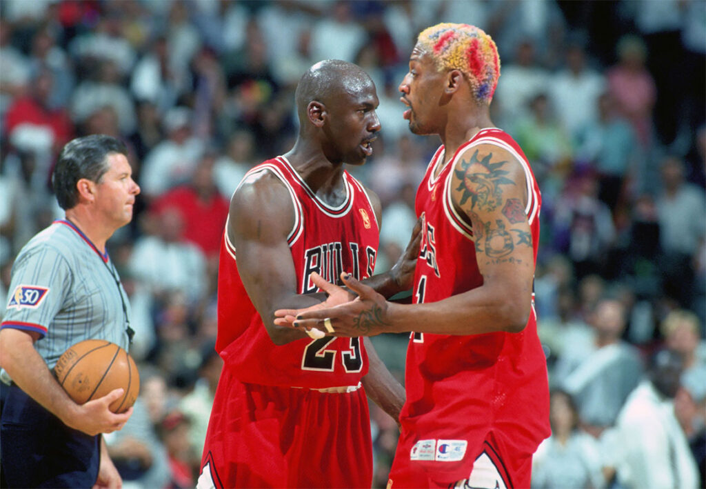Chicago Bulls forward #91 DENNIS RODMAN is held back from the official by guard #23 MICHAEL JORDAN against the Miami Heat at the Miami Arena during the 1996-97 season. 