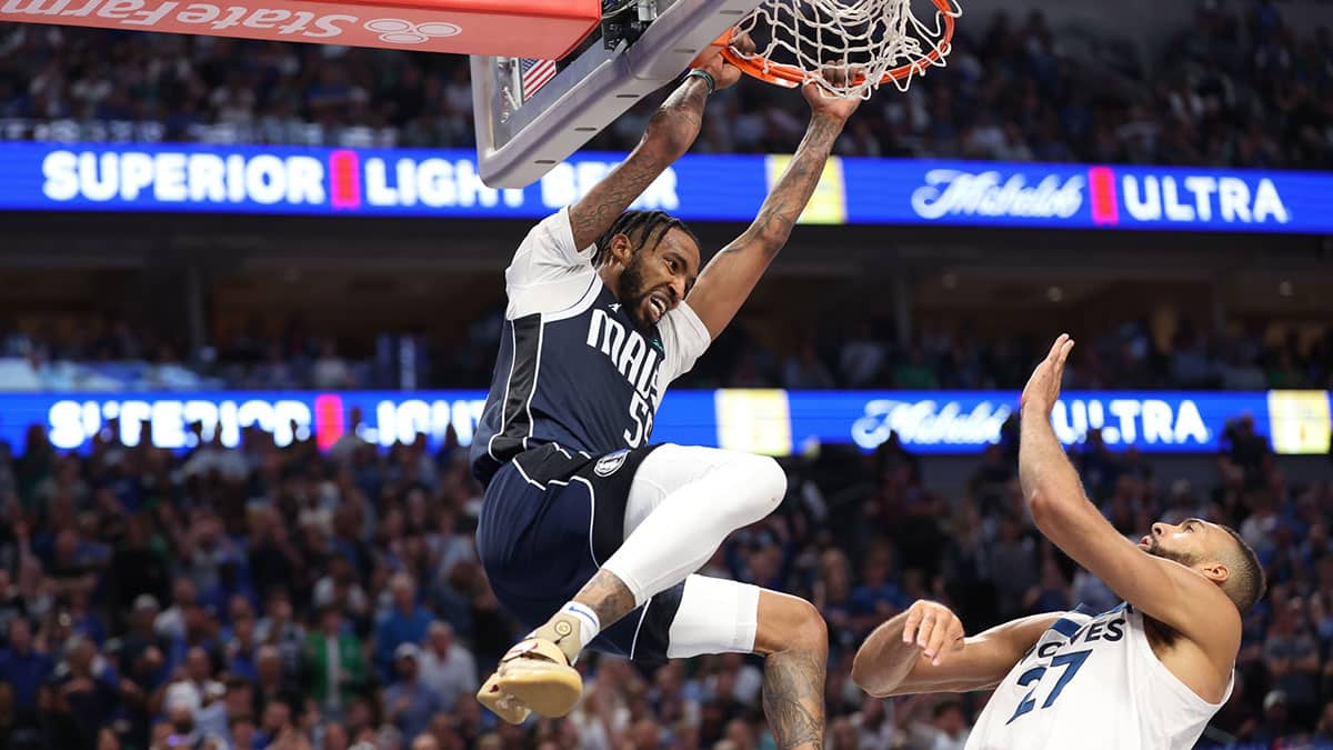 Dallas Mavericks forward Derrick Jones Jr. (55) dunks over Minnesota Timberwolves center Rudy Gobert (27) during the fourth quarter of game four of the western conference finals for the 2024 NBA playoffs at American Airlines Center. 