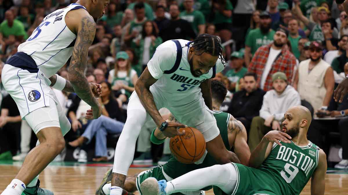 Boston Celtics guard Derrick White (9) battles for the ball against Dallas Mavericks forward Derrick Jones Jr. (55) during the fourth quarter in game five of the 2024 NBA Finals at TD Garden.