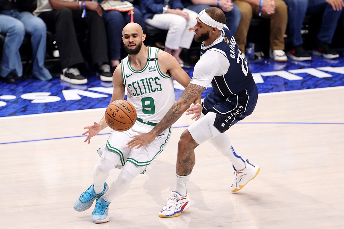 Dallas Mavericks center Daniel Gafford (21) knocks the ball away from Boston Celtics guard Derrick White (9) during the second quarter during game four of the 2024 NBA Finals at American Airlines Center.