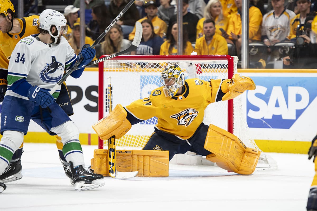 Nashville Predators goaltender Juuse Saros (74) blocks the puck against the Vancouver Canucks during the second period in game six of the first round of the 2024 Stanley Cup Playoffs at Bridgestone Arena 