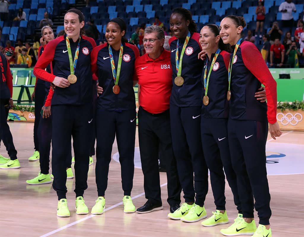 USA forward/center Breanna Stewart (9), USA forward Maya Moore (7), USA head coach Geno Auriemma, USA center Tina Charles (14), USA guard Sue Bird (6) and USA guard Diana Taurasi (12) pose for a picture after beating Spain in the women's basketball gold medal match during the Rio 2016 Summer Olympic Games.