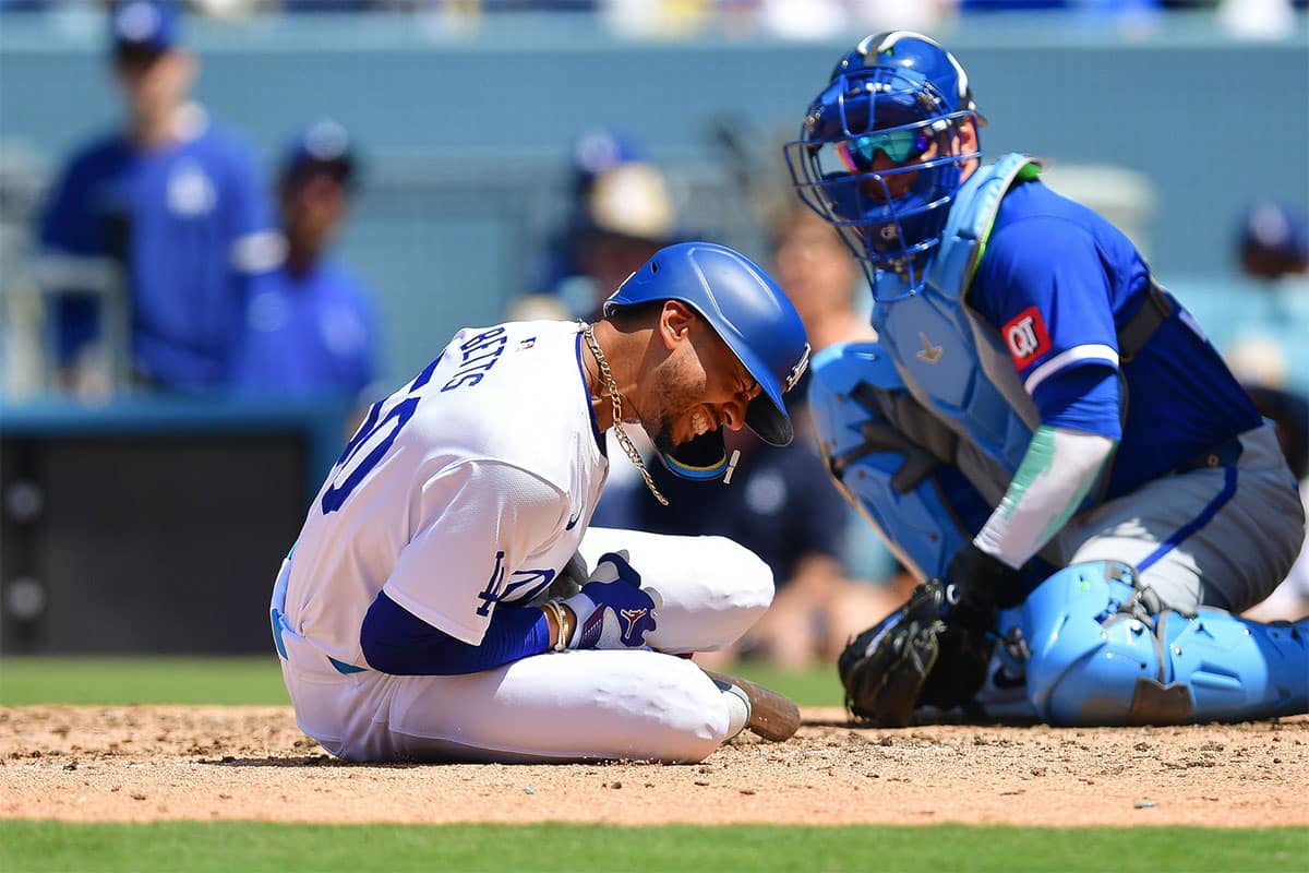 Los Angeles Dodgers shortstop Mookie Betts (50) reacts after being hit by pitch from Kansas City Royals pitcher Dan Altavilla (54) during the seventh inning at Dodger Stadium.