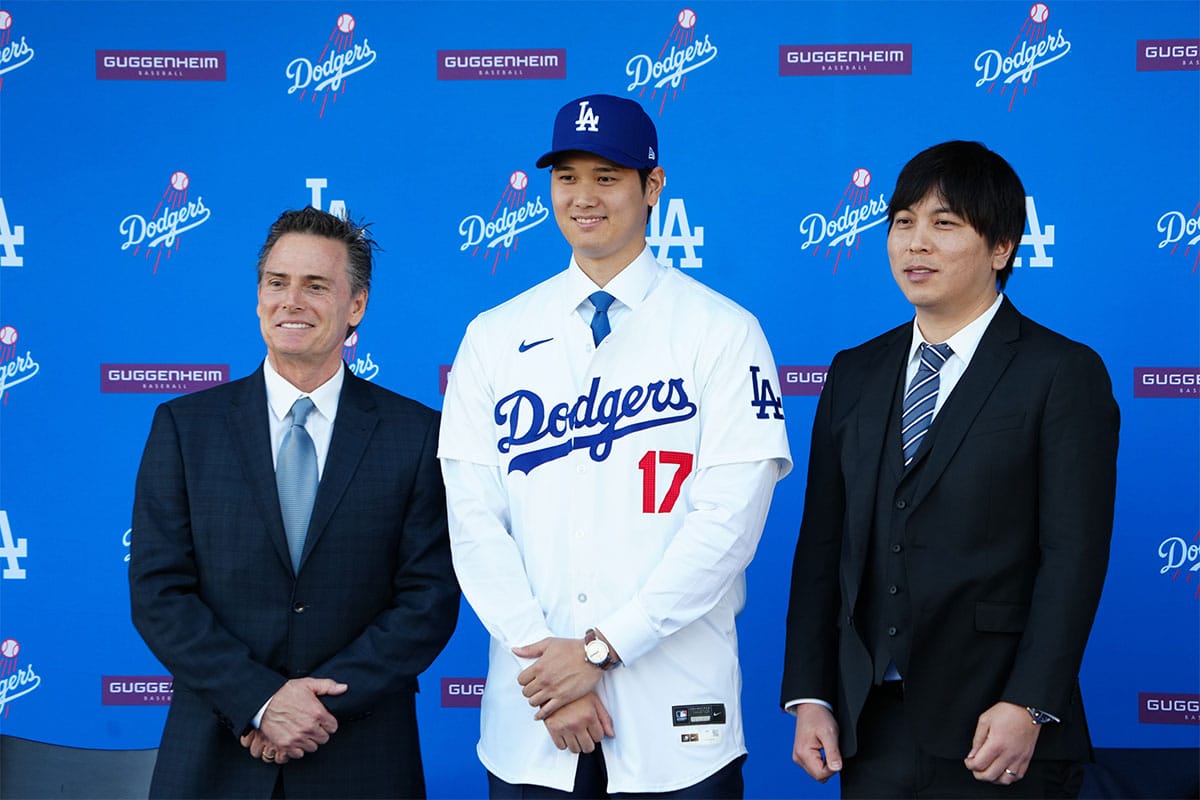 Los Angeles Dodgers player Shohei Ohtani stands with his agent Nez Balelo (left) and interpreter Ippei Mizuhara at an introductory press conference at Dodger Stadium.