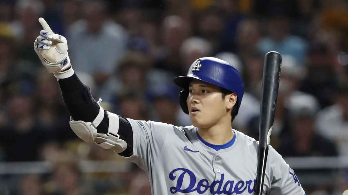 Los Angeles Dodgers designated hitter Shohei Ohtani (17) gestures for a base runner to advance on a wild pitch from the Pittsburgh Pirates during the eighth inning at PNC Park.