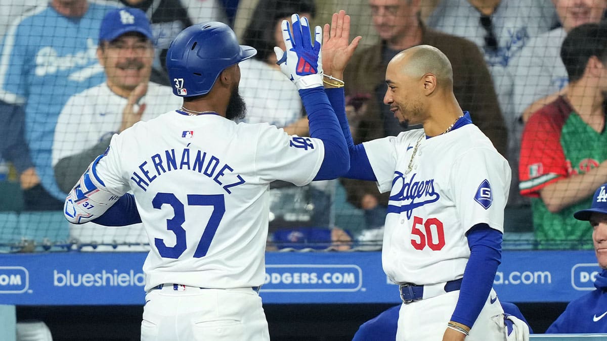 Los Angeles, California, USA; Los Angeles Dodgers left fielder Teoscar Hernandez (37) celebrates with shortstop Mookie Betts (50) after hitting a two-run home run in the sixth inning against the Texas Rangers at Dodger Stadium.