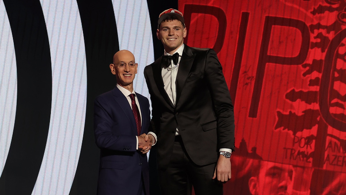 Donovan Clingan poses for photos with NBA commissioner Adam Silver after being selected in the first round by the Portland Trail Blazers in the 2024 NBA Draft at Barclays Center