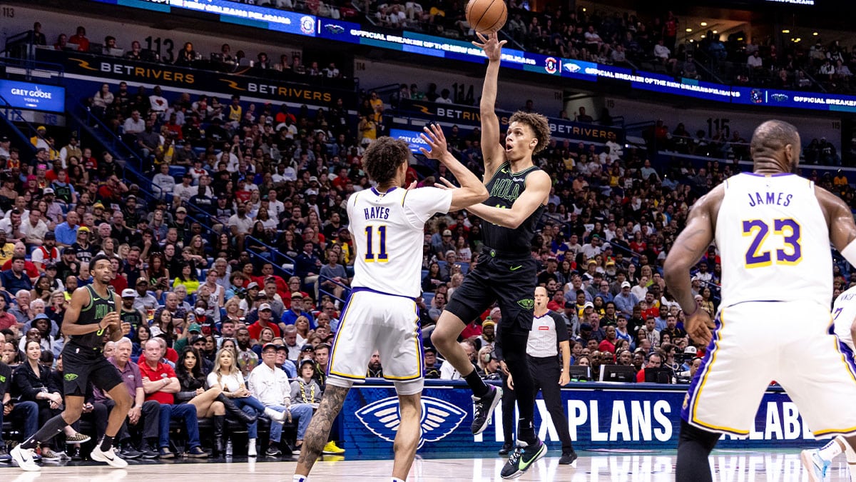 New Orleans Pelicans guard Dyson Daniels (11) shoots a jump shot against Los Angeles Lakers center Jaxson Hayes (11) during the first half at Smoothie King Center