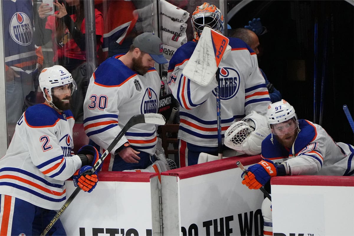 Edmonton Oilers forward Connor McDavid (97) and goaltender Calvin Pickard (30) and defenseman Evan Bouchard (2) react to the loss against the Florida Panthers in game seven of the 2024 Stanley Cup Final at Amerant Bank Arena.