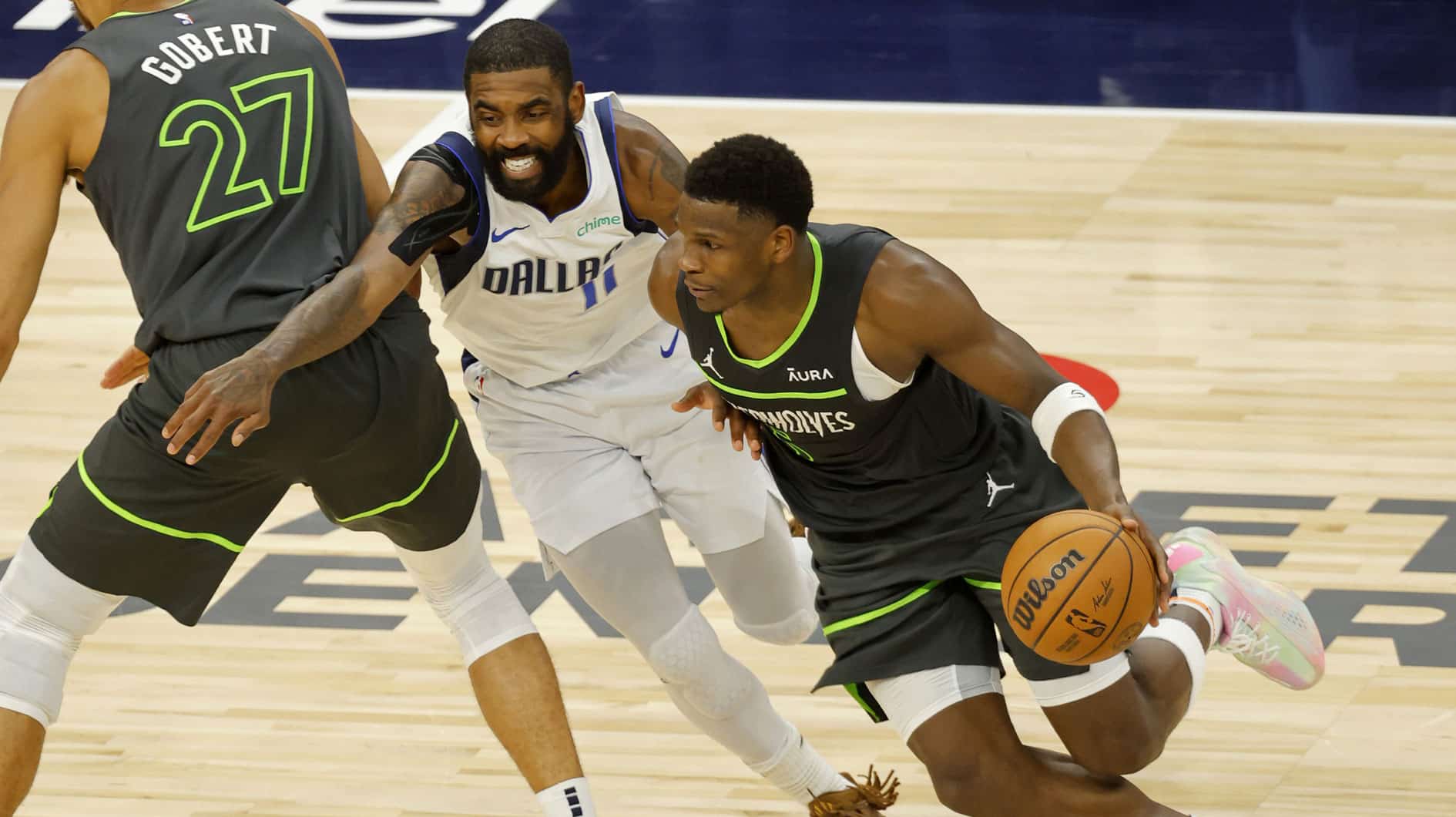 May 30, 2024; Minneapolis, Minnesota, USA; Minnesota Timberwolves guard Anthony Edwards (5) dribbles against Dallas Mavericks guard Kyrie Irving (11) during the second half in game five of the western conference finals for the 2024 NBA playoffs at Target Center.
