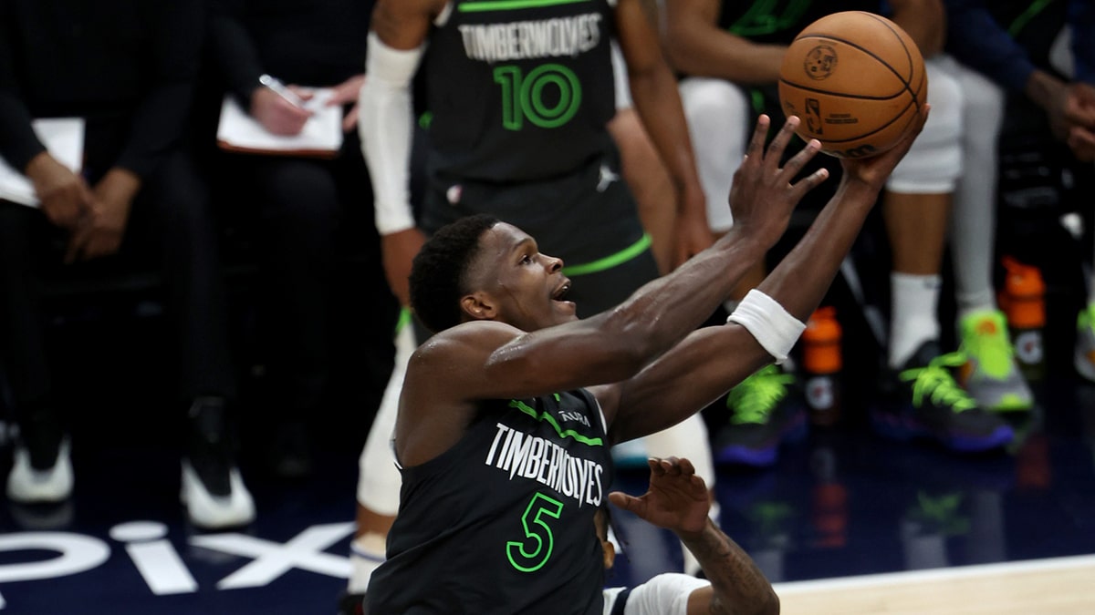 Minnesota Timberwolves guard Anthony Edwards (5) shoots against Dallas Mavericks guard Luka Doncic (77) during the second quarter in game five of the western conference finals for the 2024 NBA playoffs at Target Center.