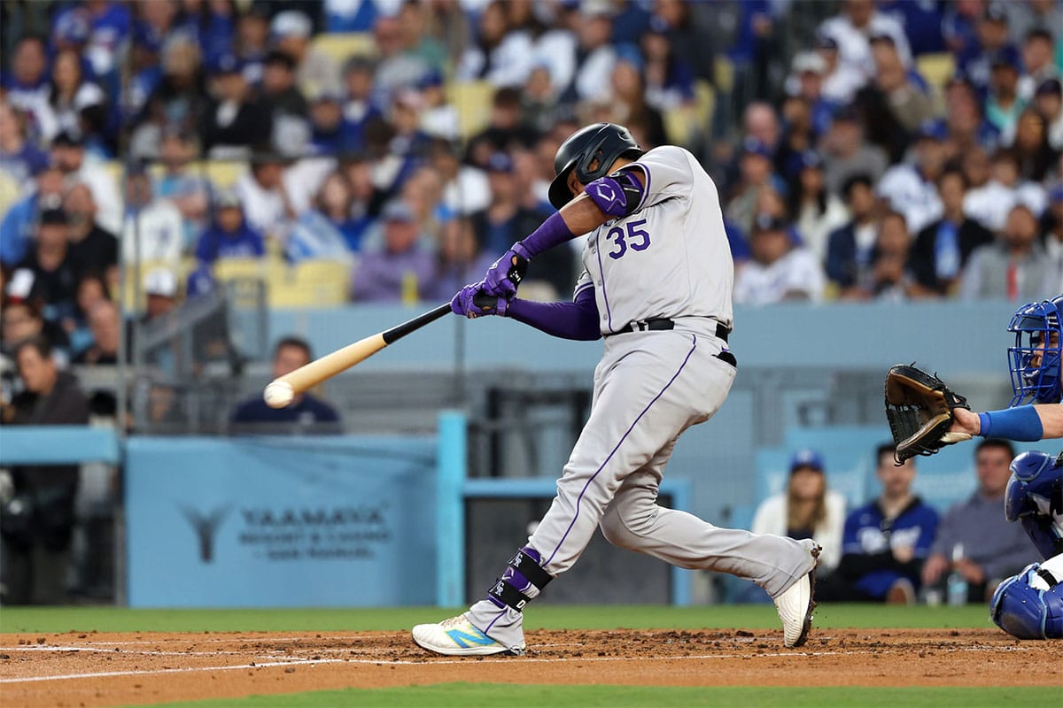 Colorado Rockies catcher Elias Diaz (35) hits a single during the third inning against the Los Angeles Dodgers at Dodger Stadium.
