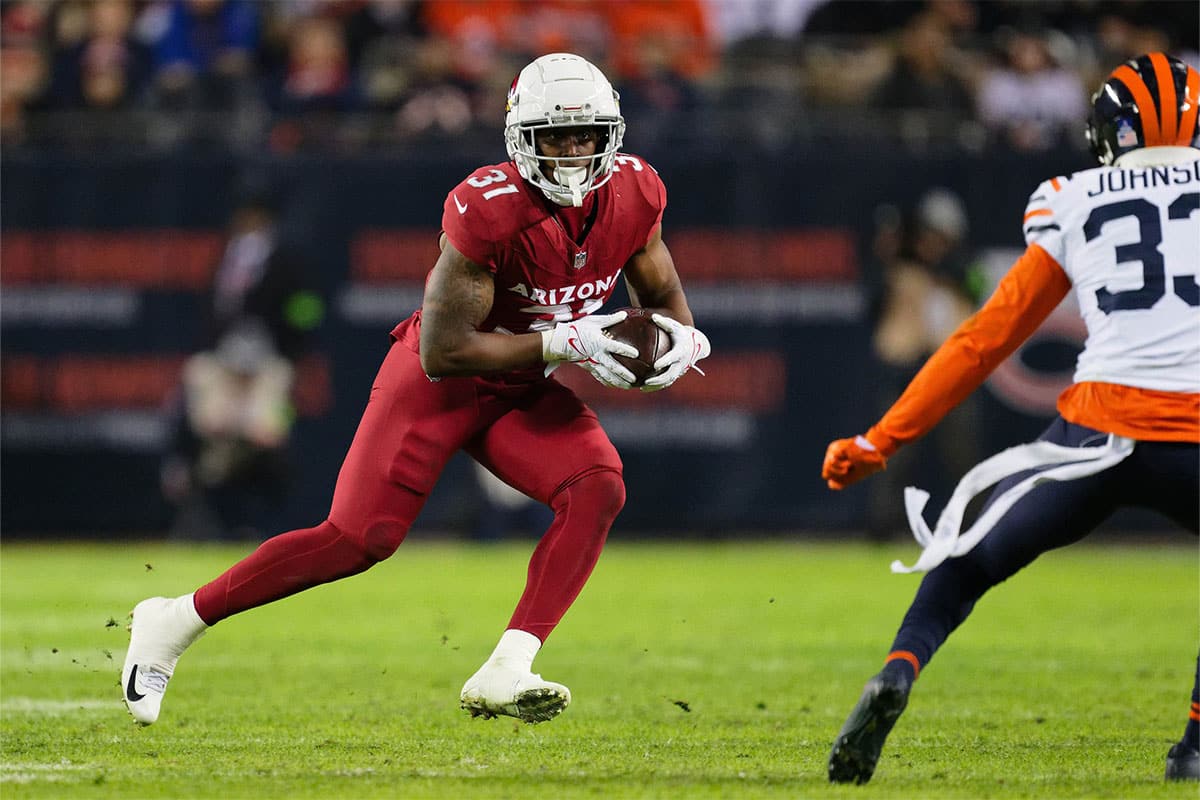 Dec 24, 2023; Chicago, Illinois, USA; Arizona Cardinals running back Emari Demercado (31) runs with the ball against the Chicago Bears at Soldier Field. 