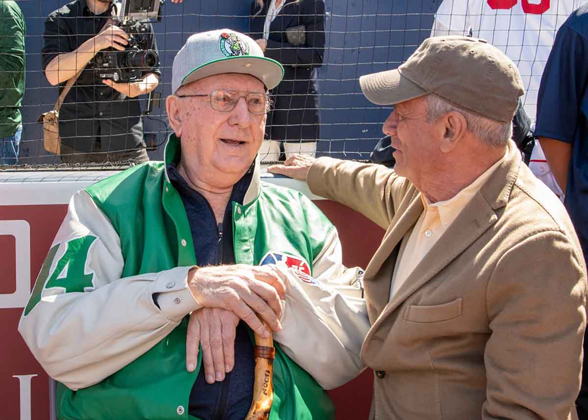 Celtic legend Bob Cousy talks with Larry Lucchino, chairman and part-owner of the Worcester Red Sox, before the home opener at Polar Park 