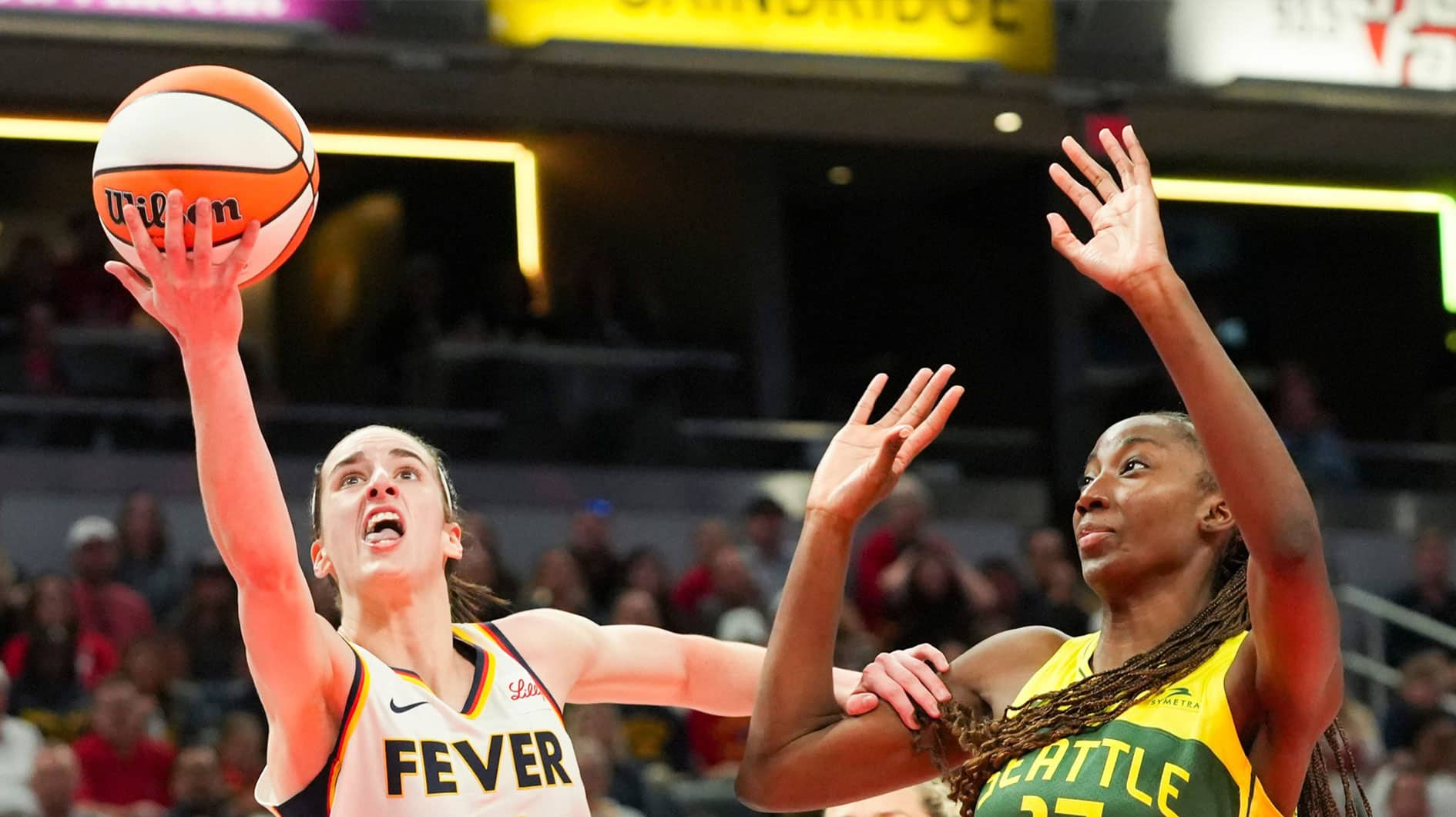 Indiana Fever guard Caitlin Clark (22) attempts a lay up while being defended by Seattle Storm center Ezi Magbegor (13) on Thursday, May 30, 2024, during the WNBA game. The Seattle Storm defeated the Indiana Fever 103-88.
