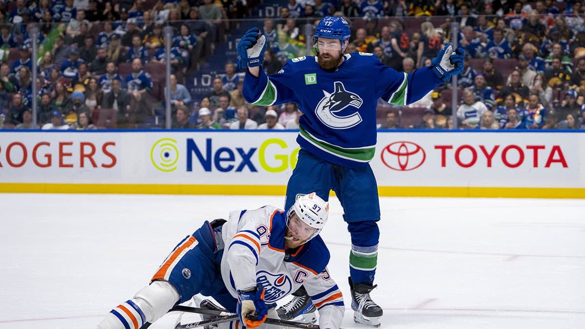 Vancouver Canucks defenseman Filip Hronek (17) checks Edmonton Oilers forward Connor McDavid (97) during the second period in game seven of the second round of the 2024 Stanley Cup Playoffs at Rogers Arena.