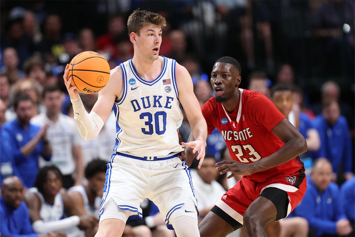 Duke Blue Devils center Kyle Filipowski (30) controls the ball against North Carolina State Wolfpack forward Mohamed Diarra (23) in the second half in the finals of the South Regional of the 2024 NCAA Tournament at American Airline Center
