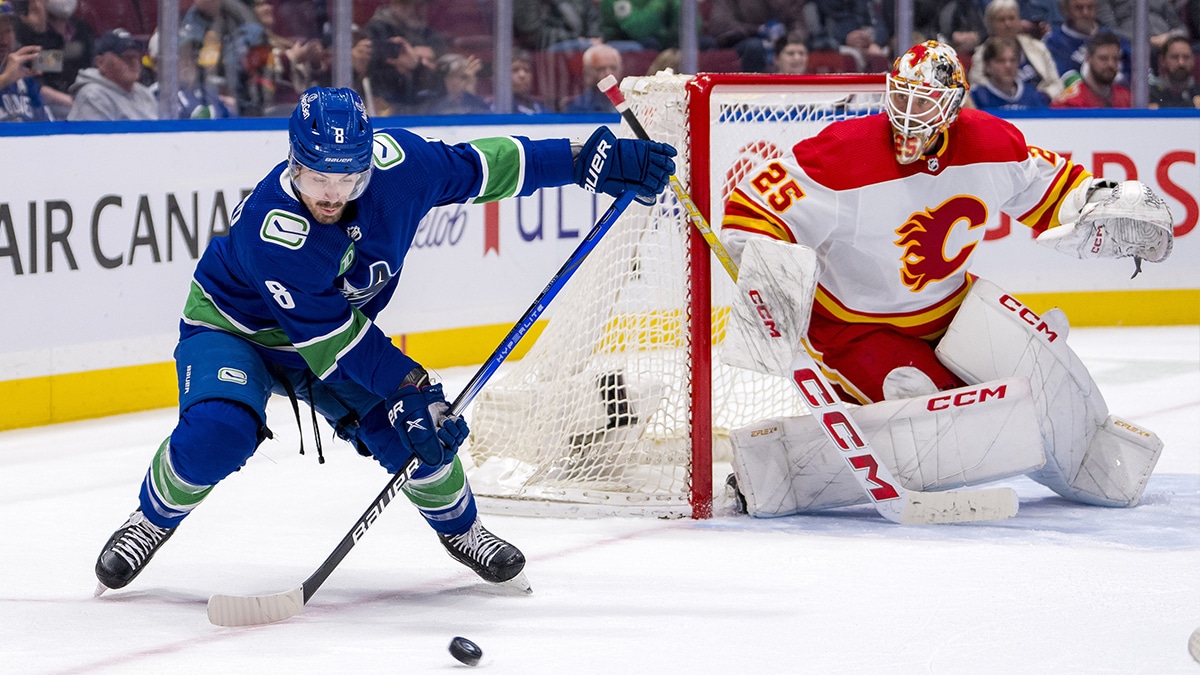 Calgary Flames goalie Jacob Markstrom (25) watches Vancouver Canucks forward Conor Garland (8) handle the puck in the third period at Rogers Arena. Canucks won 4 -1.