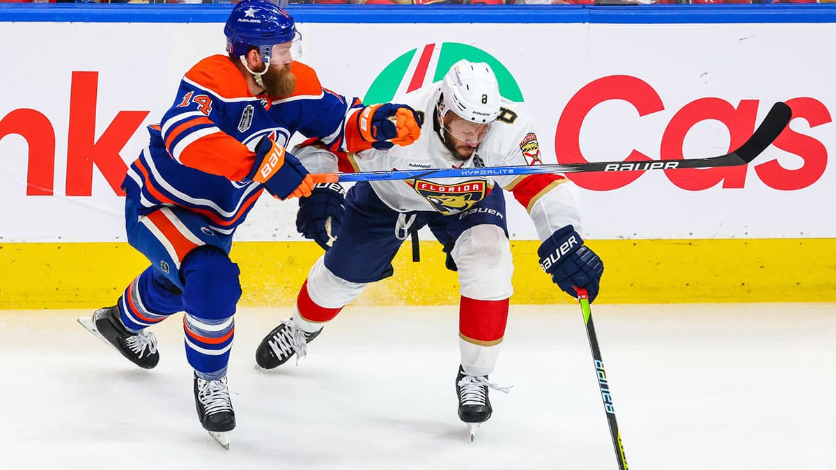 Jun 15, 2024; Edmonton, Alberta, CAN; Florida Panthers right wing Kyle Okposo (8) and Edmonton Oilers defenseman Mattias Ekholm (14) battles for the puck during the second period in game four of the 2024 Stanley Cup Final at Rogers Place. Mandatory Credit: Sergei Belski-USA TODAY Sports