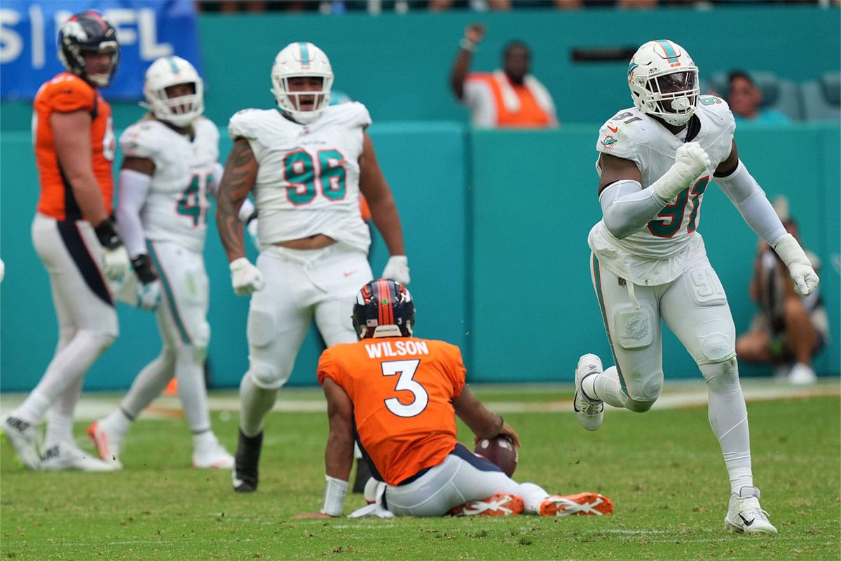 Miami Dolphins defensive end Emmanuel Ogbah (91) celebrates a sack Denver Broncos quarterback Russell Wilson (3) during the fourth quarter of an NFL game at Hard Rock Stadium in Miami Gardens