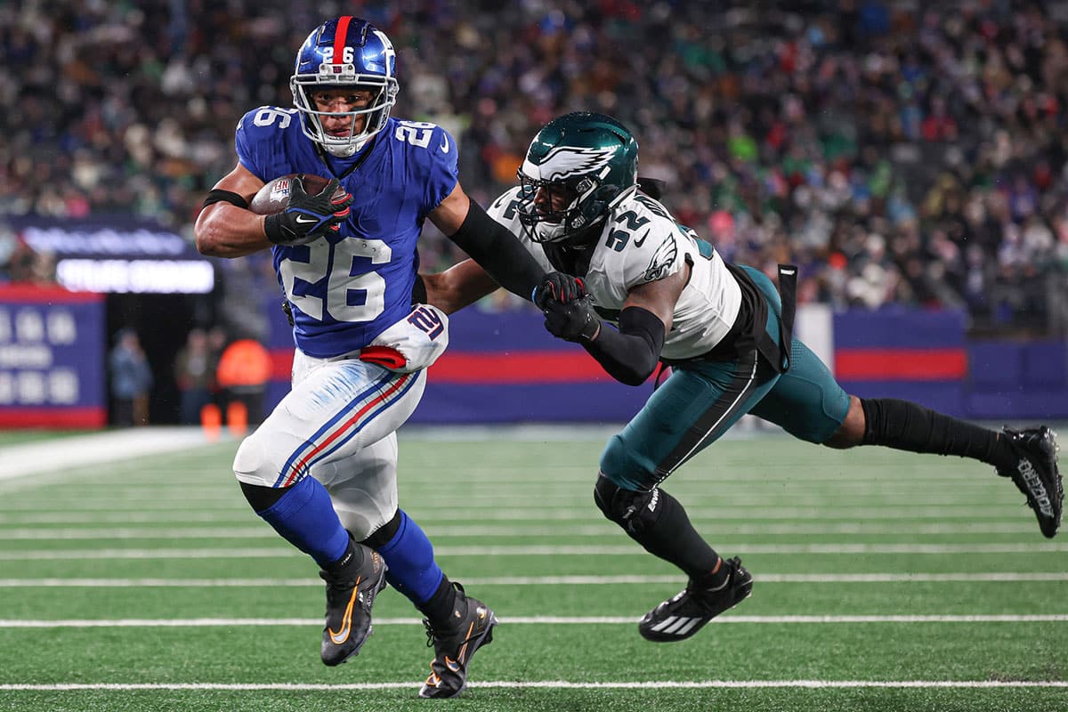 New York Giants running back Saquon Barkley (26) breaks a tackle by Philadelphia Eagles linebacker Zach Cunningham (52) for a rushing touchdown during the first half at MetLife Stadium.