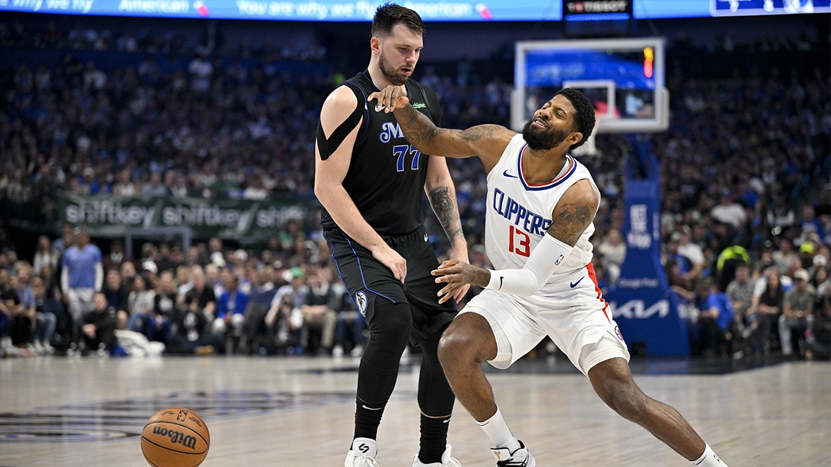  LA Clippers forward Paul George (13) is fouled by Dallas Mavericks guard Luka Doncic (77) during the first quarter during game six of the first round for the 2024 NBA playoffs at American Airlines Center.
