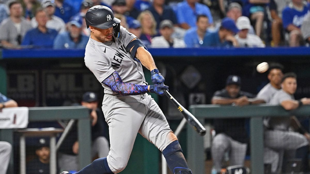 New York Yankees designated hitter Giancarlo Stanton (27) hits a solo home run in the seventh inning against the Kansas City Royals at Kauffman Stadium