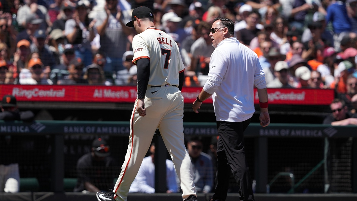 San Francisco Giants starting pitcher Blake Snell (7) walks off of the field with athletic trainer Dave Groeschner (right) during the fifth inning against the New York Yankees at Oracle Park