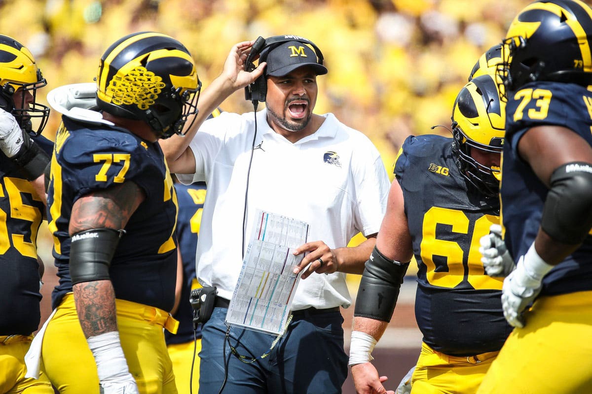 Michigan tight ends coach Grant Newsome talks to players at a timeout during the second half of U-M's 30-3 win