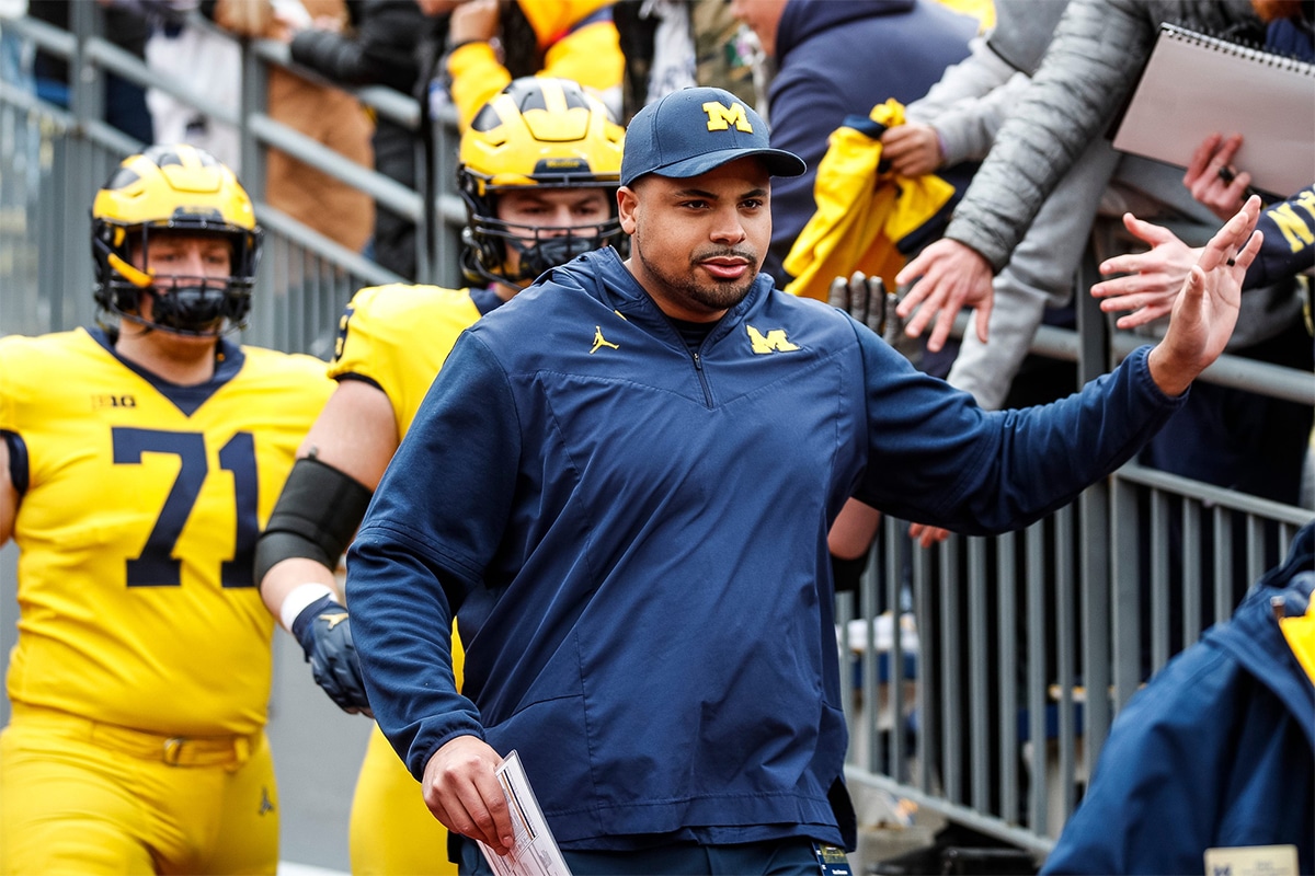 Michigan offensive line coach Grant Newsome talks to Blue Team players during the second half of the spring game at Michigan Stadium
