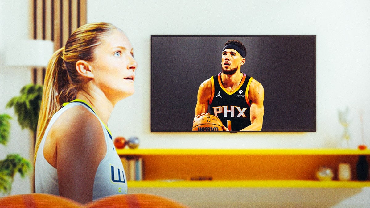 Wings Jacy Sheldon on left watching a TV. On the TV, need Suns Devin Booker shooting a basketball.