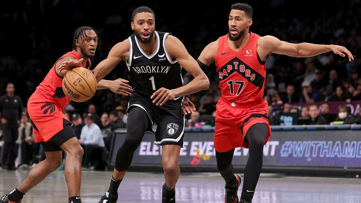 Brooklyn Nets forward Mikal Bridges (1) drives to the basket between Toronto Raptors guard Immanuel Quickley (5) and forward Garrett Temple (17) during the first quarter at Barclays Center.