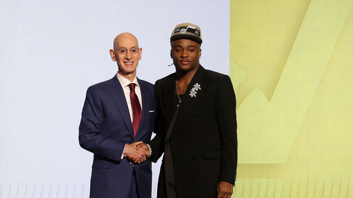 Isaiah Collier poses for photos with NBA commissioner Adam Silver after being selected in the first round by the Utah Jazz in the 2024 NBA Draft at Barclays Center.