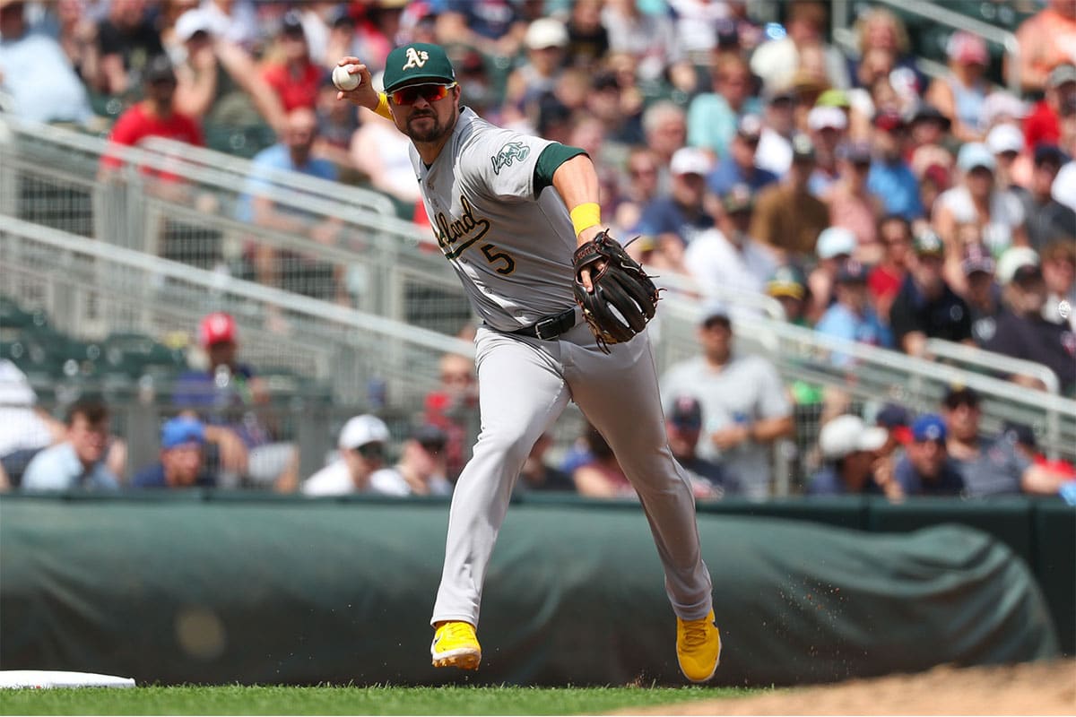 Oakland Athletics third baseman J.D. Davis (5) throws the ball to first base to get out Minnesota Twins left fielder Willi Castro (50) during the seventh inning of game one of a double header at Target Field