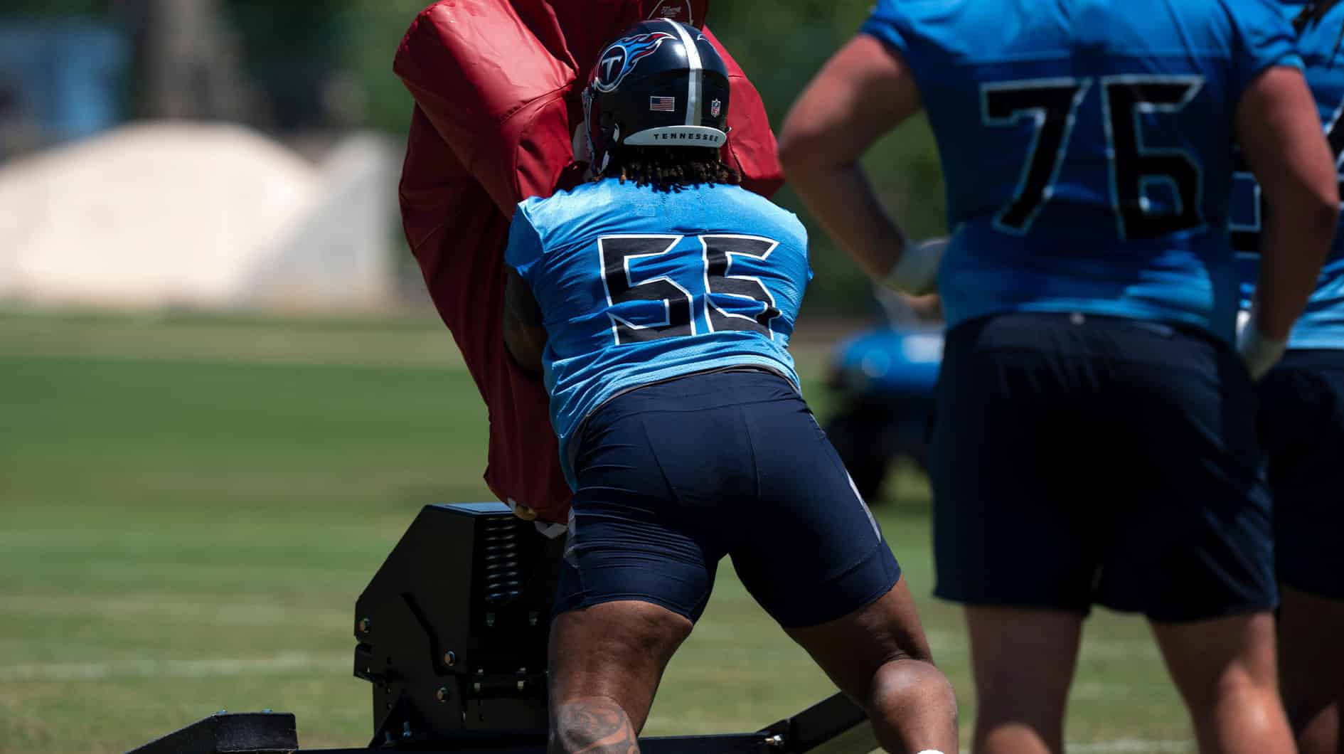 Tackle JC Latham (55) takes on the sled during Tennessee Titans practice at Ascension Saint Thomas Sports Park in Nashville, Tenn