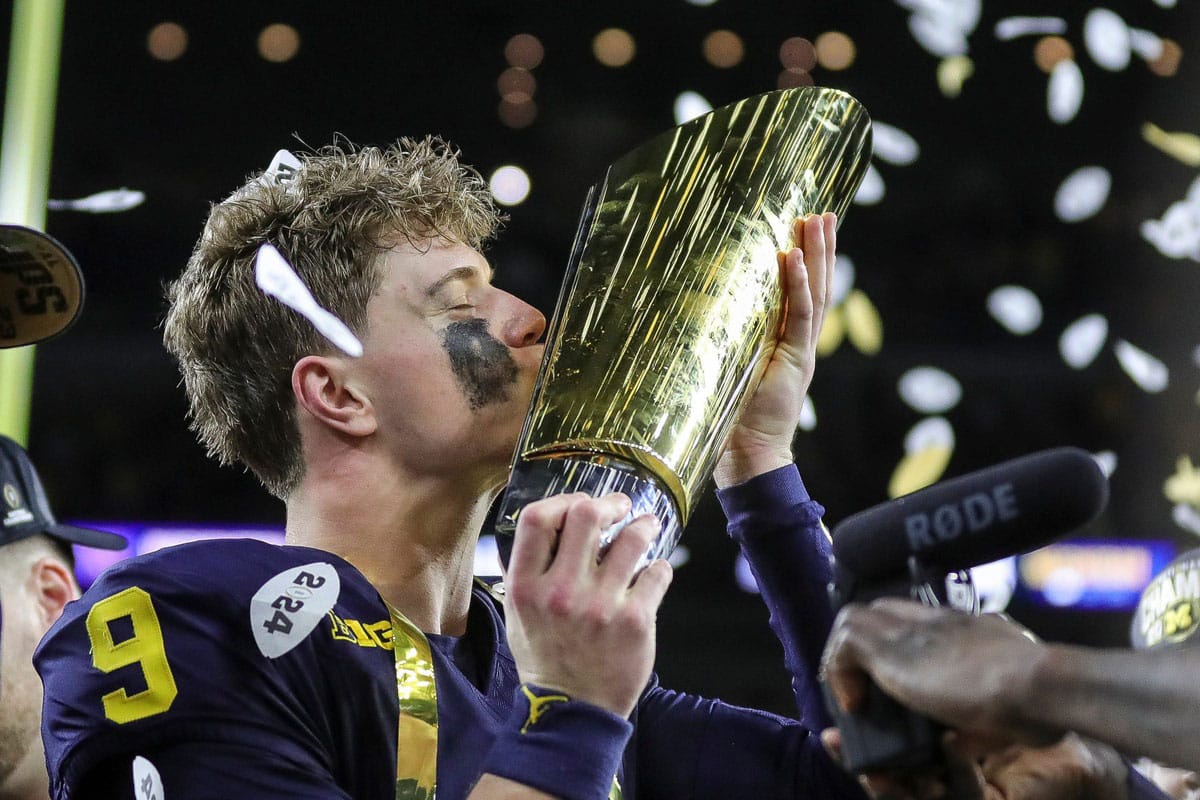 Michigan quarterback J.J. McCarthy misses the trophy to celebrate 34-13 win over Washington at the national championship game at NRG Stadium in Houston on Monday, Jan. 8, 2024.