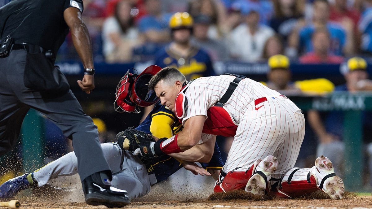 Philadelphia Phillies catcher J.T. Realmuto (10) tags out Milwaukee Brewers third base Oliver Dunn (15) at the plate during the tenth inning at Citizens Bank Park.