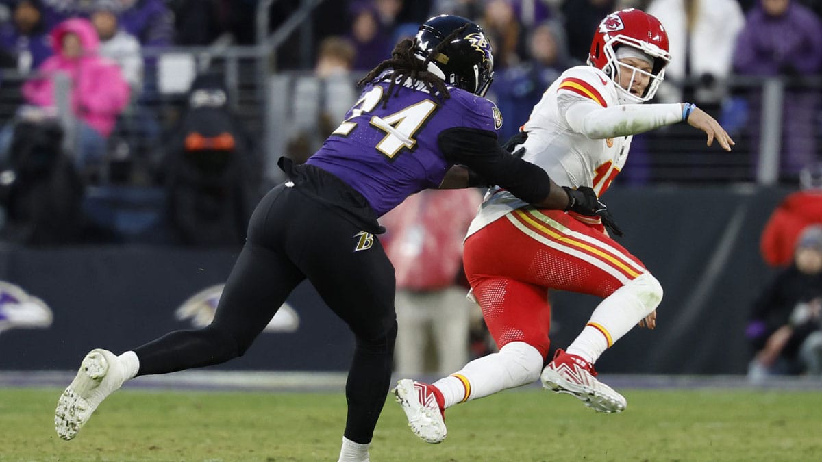 Jan 28, 2024; Baltimore, Maryland, USA; Kansas City Chiefs quarterback Patrick Mahomes (15) is knocked down after passing the ball by Baltimore Ravens linebacker Jadeveon Clowney (24) in the AFC Championship football game at M&T Bank Stadium.