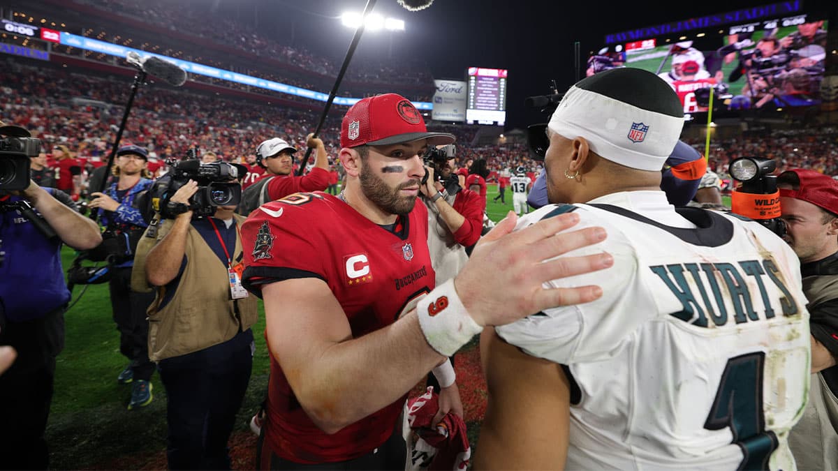Tampa Bay Buccaneers quarterback Baker Mayfield (6) and Philadelphia Eagles quarterback Jalen Hurts (1) meet on the field after a 2024 NFC wild card game at Raymond James Stadium. 