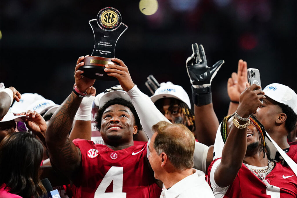 Alabama Crimson Tide quarterback Jalen Milroe (4) celebrates with the most valuable player trophy after the Alabama Crimson Tide defeated the Georgia Bulldogs in the SEC Championship at Mercedes-Benz Stadium.