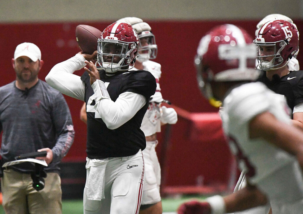 Alabama quarterback Jalen Milroe (4) throws pass routes during practice in the Hank Crisp Indoor Practice Facility at the University of Alabama.