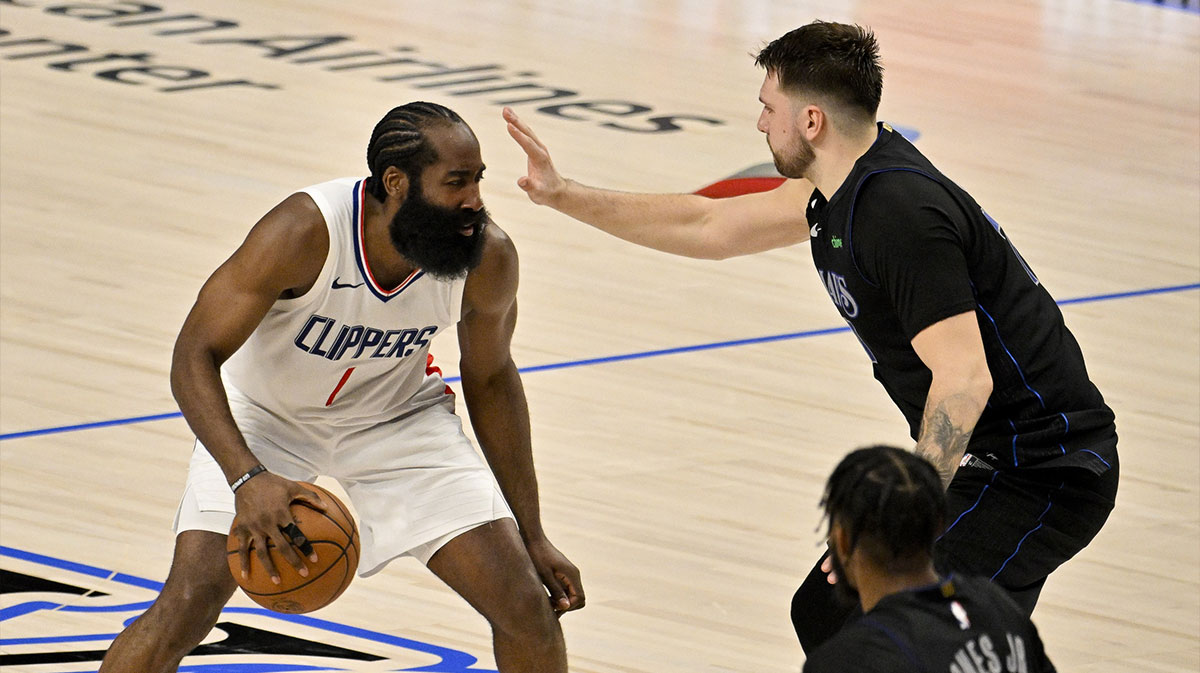 LA Clippers guard James Harden (1) looks to move the ball past Dallas Mavericks guard Luka Doncic (77) during the fourth quarter during game six of the first round for the 2024 NBA playoffs at American Airlines Center.