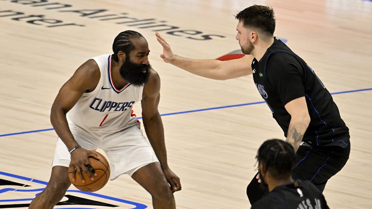 LA Clippers guard James Harden (1) looks to move the ball past Dallas Mavericks guard Luka Doncic (77) during the fourth quarter during game six of the first round for the 2024 NBA playoffs at American Airlines Center.