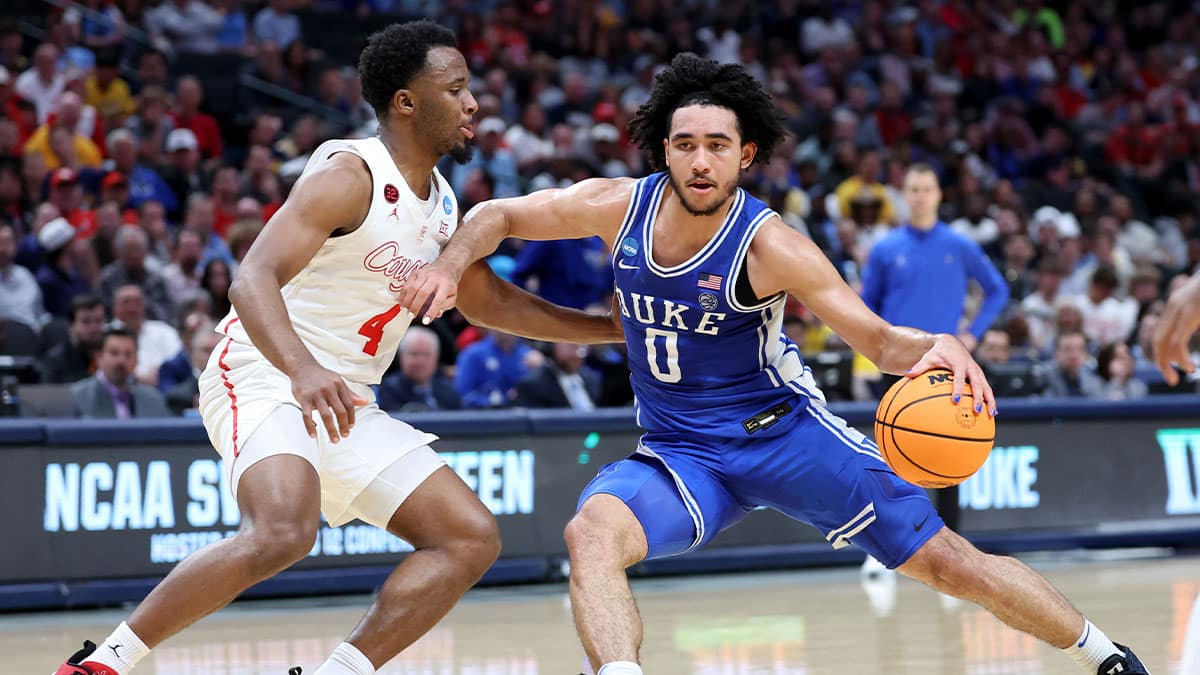 Duke Blue Devils guard Jared McCain (0) drives against Houston Cougars guard L.J. Cryer (4) during the first half in the semifinals of the South Regional of the 2024 NCAA Tournament at American Airlines Center.