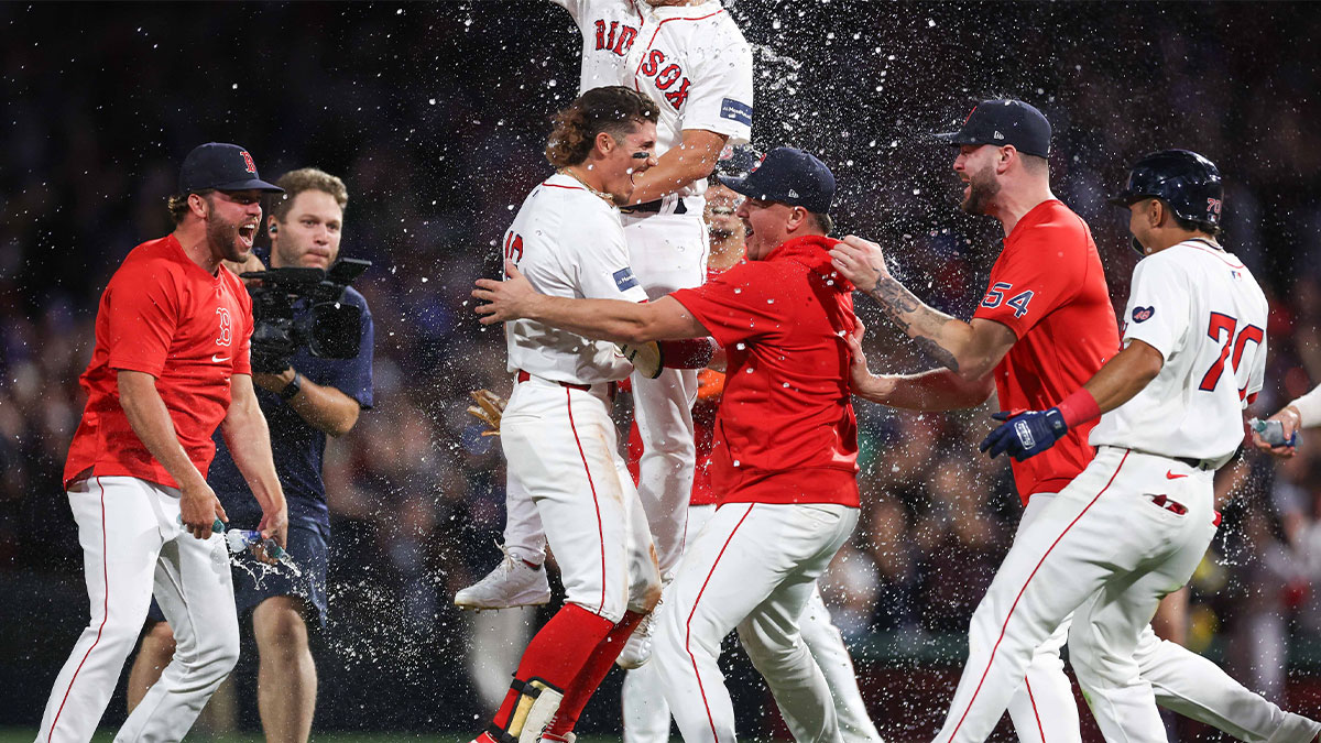 Boston Red Sox left fielder Jarren Duran (16) celebrates with teammates after hitting a game winning RBI single during the ninth inning against the Toronto Blue Jays at Fenway Park