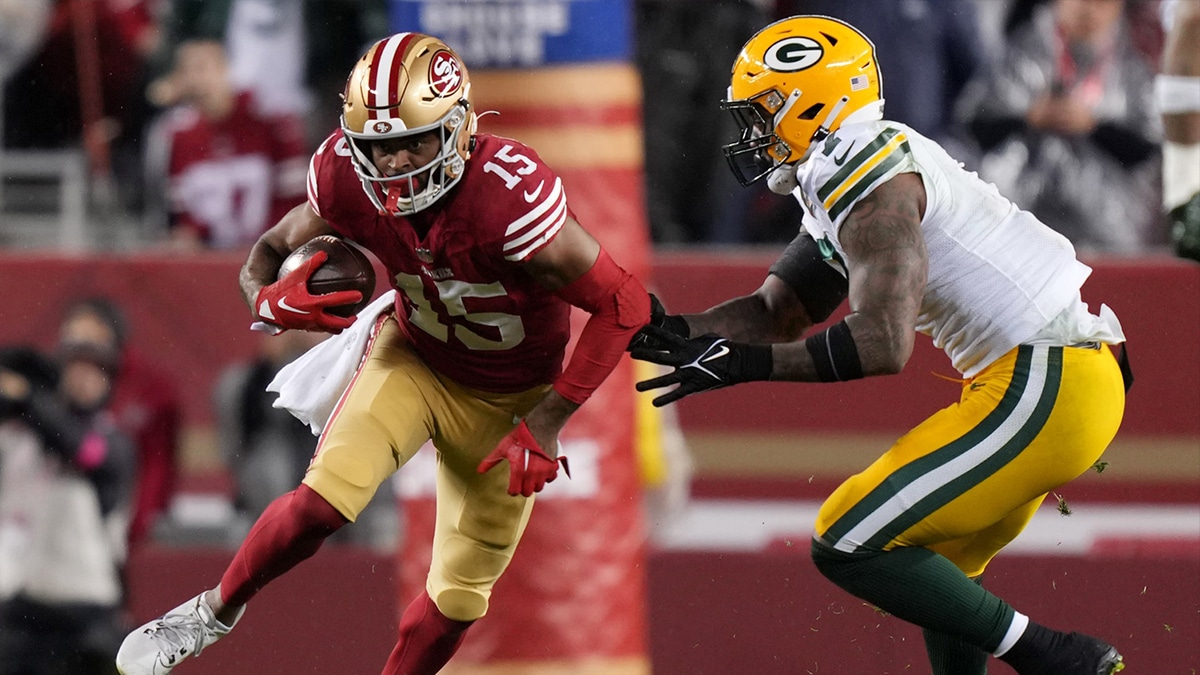 San Francisco 49ers wide receiver Jauan Jennings (15) runs against Green Bay Packers linebacker Quay Walker (7) during the second quarter in a 2024 NFC divisional round game at Levi's Stadium. 