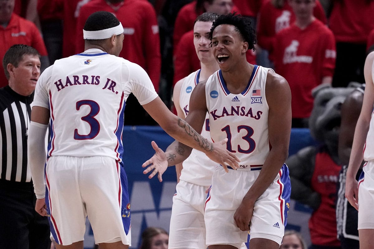 Kansas Jayhawks guard Elmarko Jackson (13) celebrates with guard Dajuan Harris Jr. (3) during the second half in the first round of the 2024 NCAA Tournament against the Samford Bulldogs at Vivint Smart Home Arena-Delta Center.