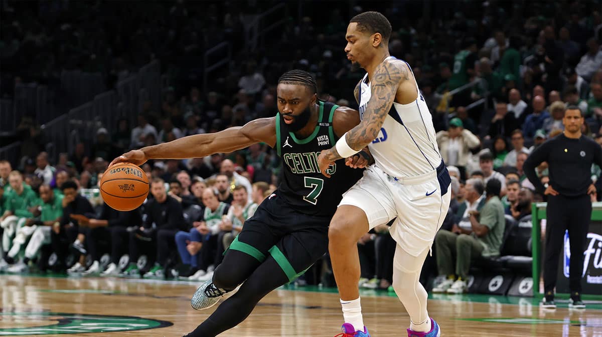 Boston Celtics guard Jaylen Brown (7) dribbles the ball against Dallas Mavericks forward P.J. Washington (25) during the third quarter in game two of the 2024 NBA Finals at TD Garden.